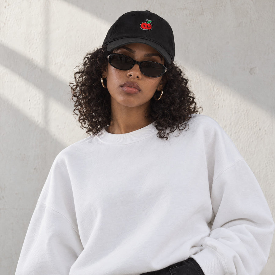 Model wearing the Access Cap, front view, in a sunlit studio