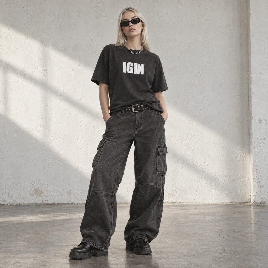 Model wearing the Globe Heavy Faded Tee, front view, in a sunlit studio