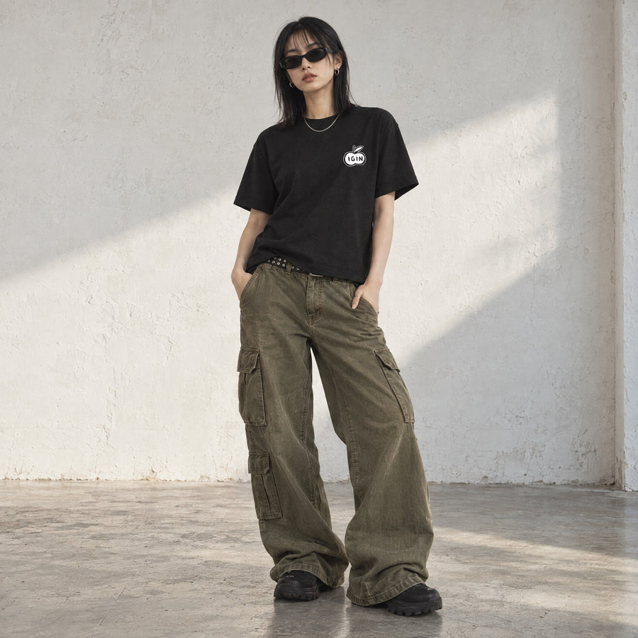 Model wearing the Where Smiles Begin Box Tee, front view, in a sunlit studio