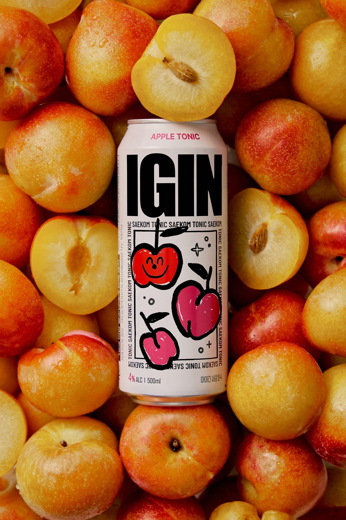 A SAEKOM Apple Tonic on a pile of plums, cropped into a heart
