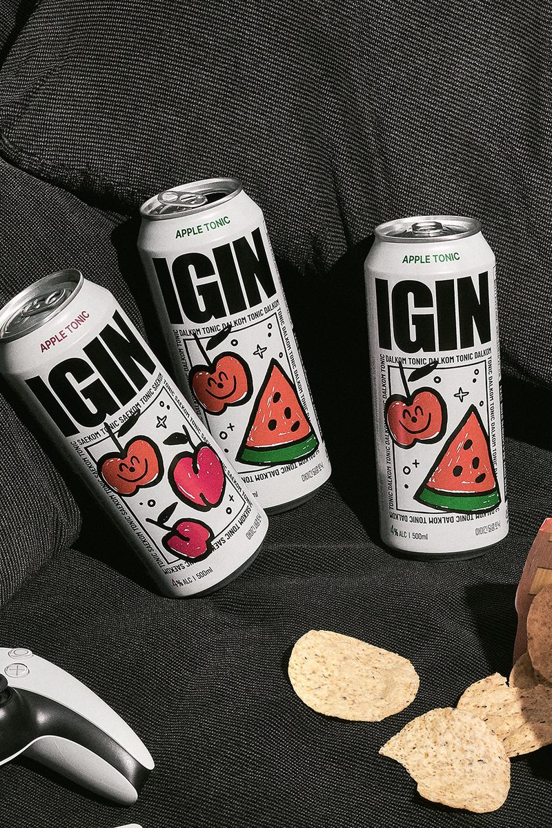 Apple Tonic cans on a couch with snacks and a game controller
