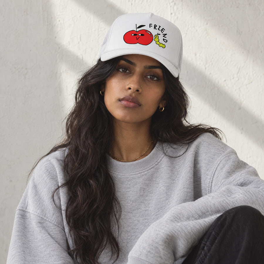 Model wearing the Friend Foam Trucker, front view, in a sunlit studio
